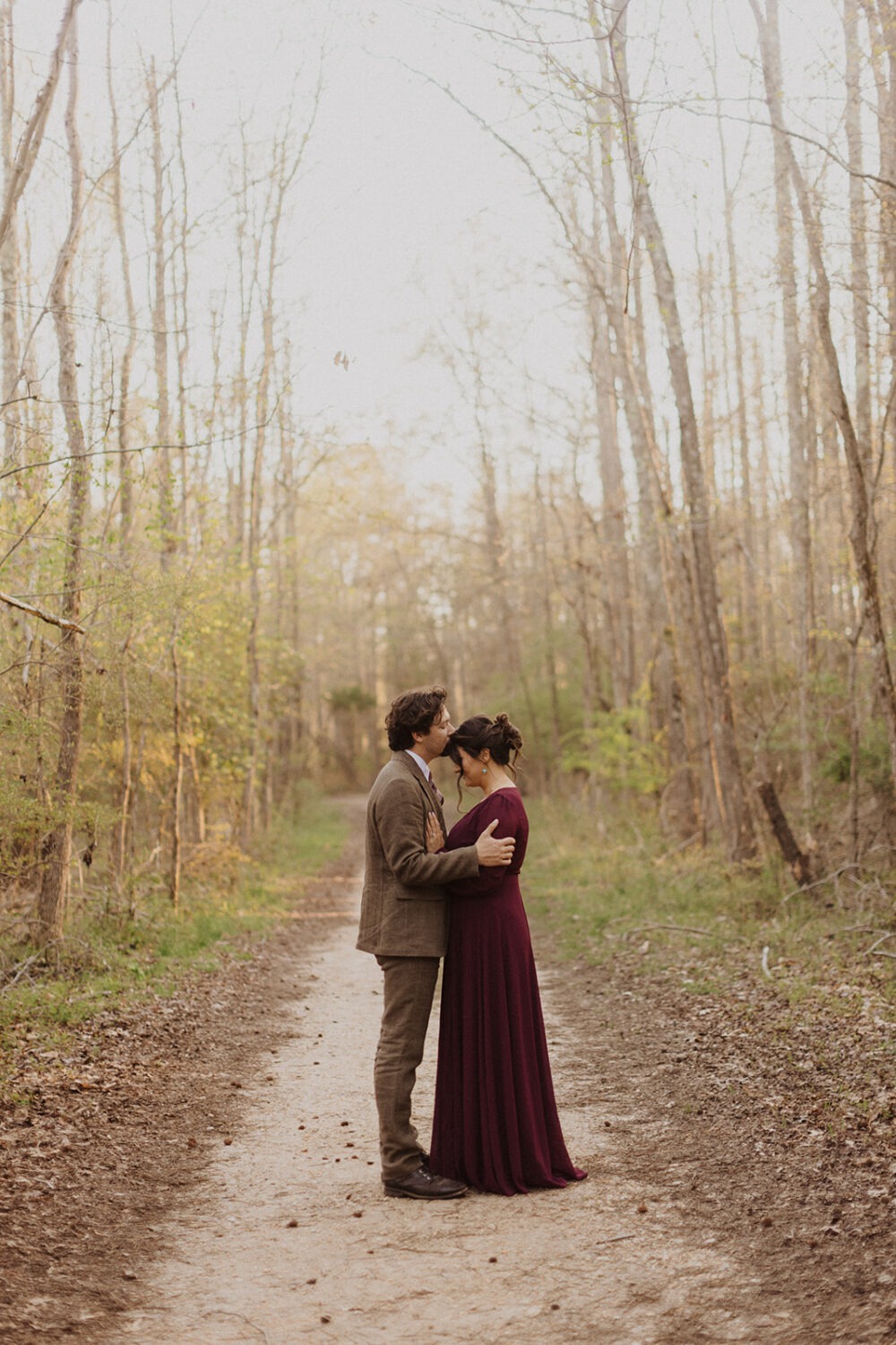 couple kisses in woods couples session