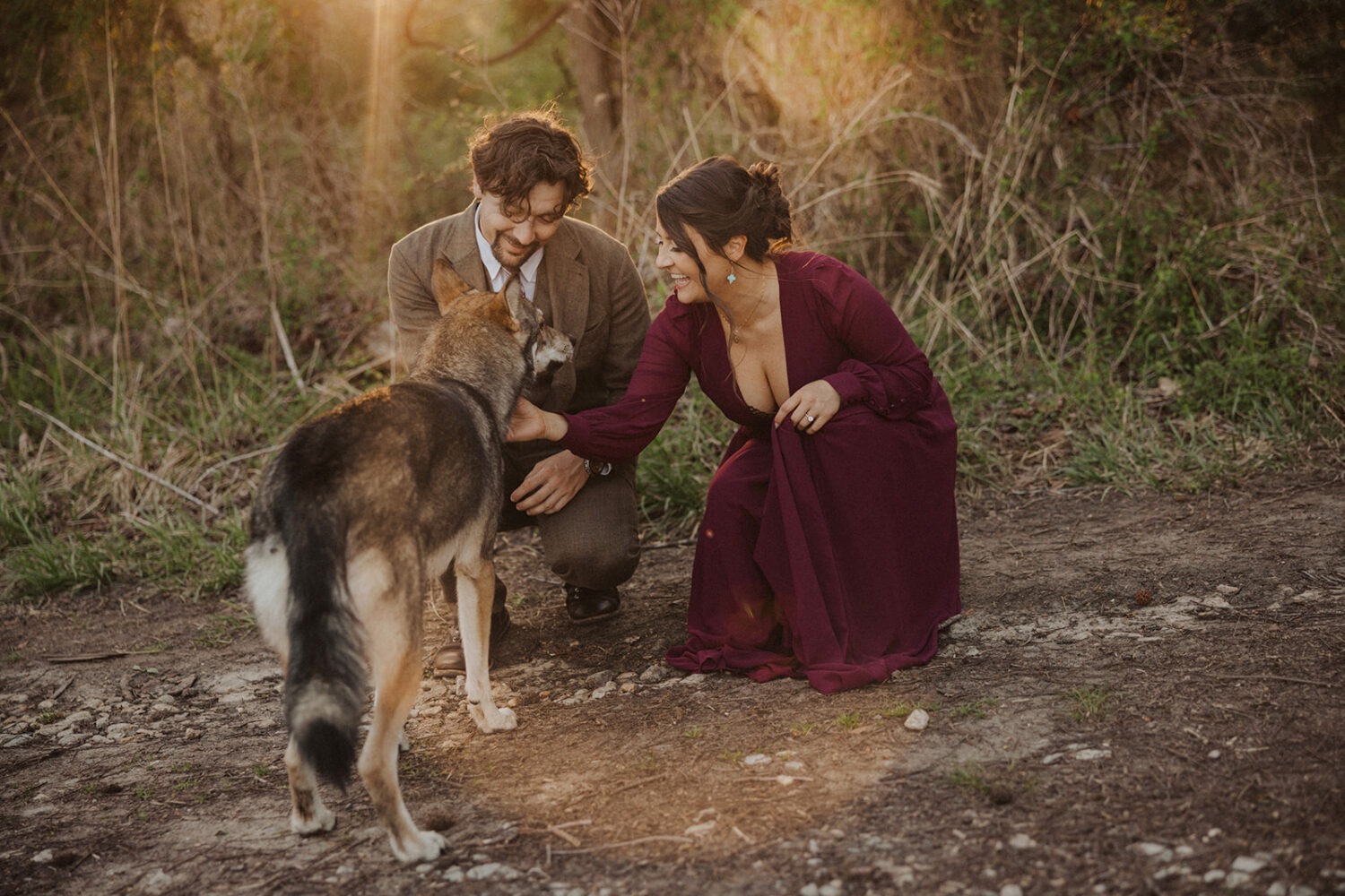 couple greets dog at sunset couples session