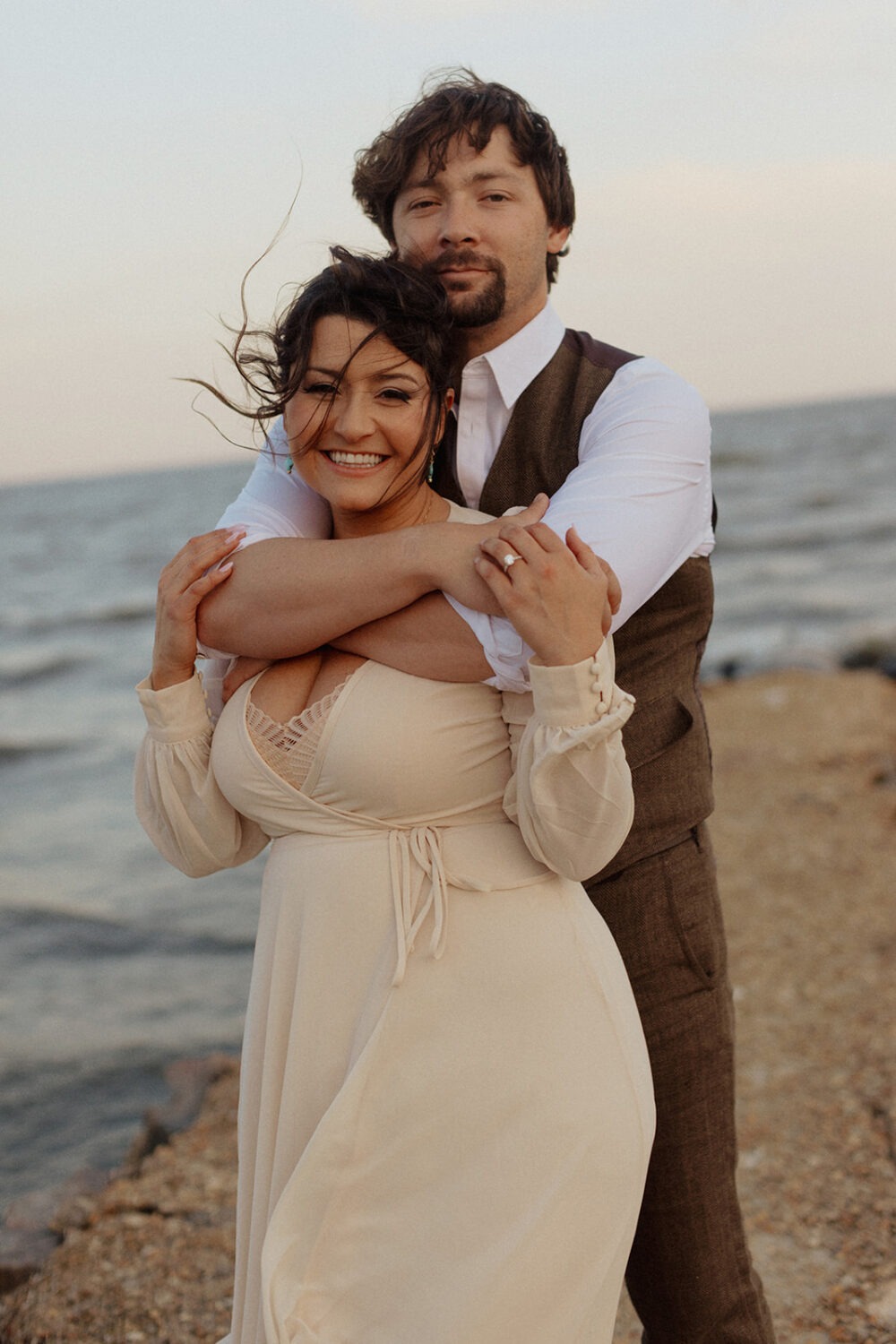 couple embraces at beach photo shoot