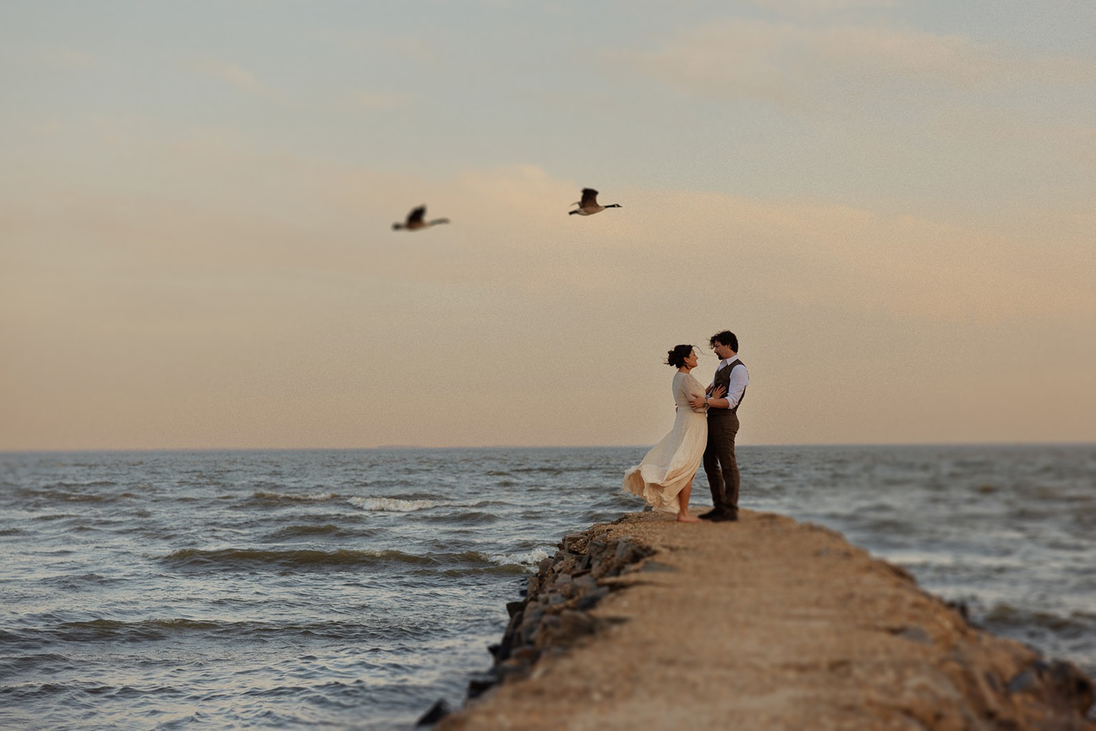 couple embraces at beach engagement session