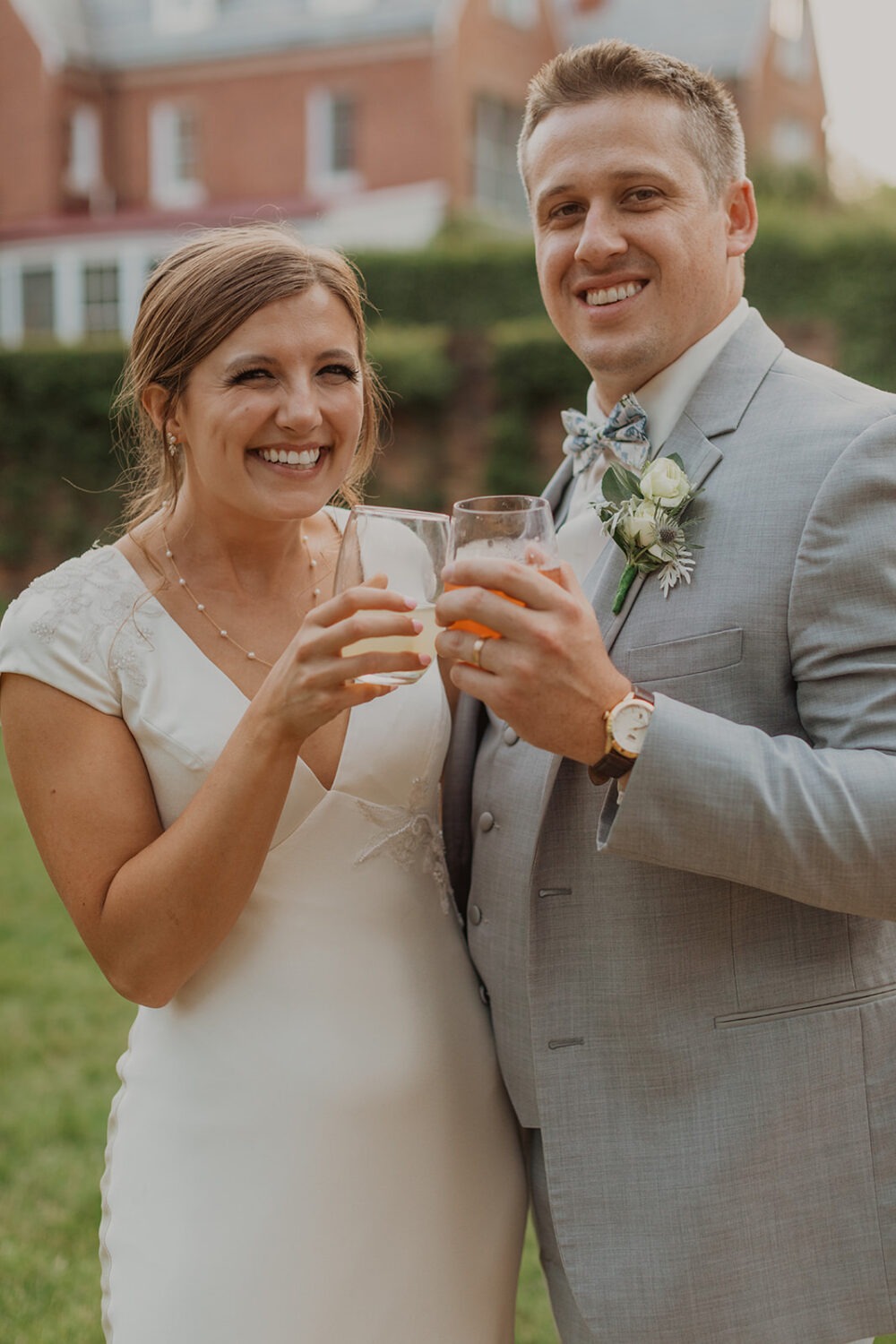 couple cheers at wedding cocktail hour