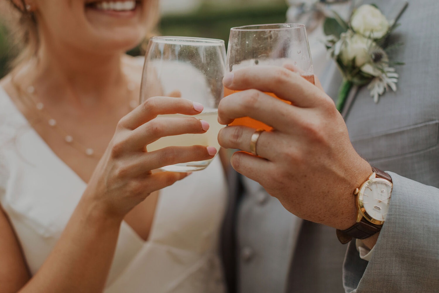 couple cheers at wedding cocktail hour