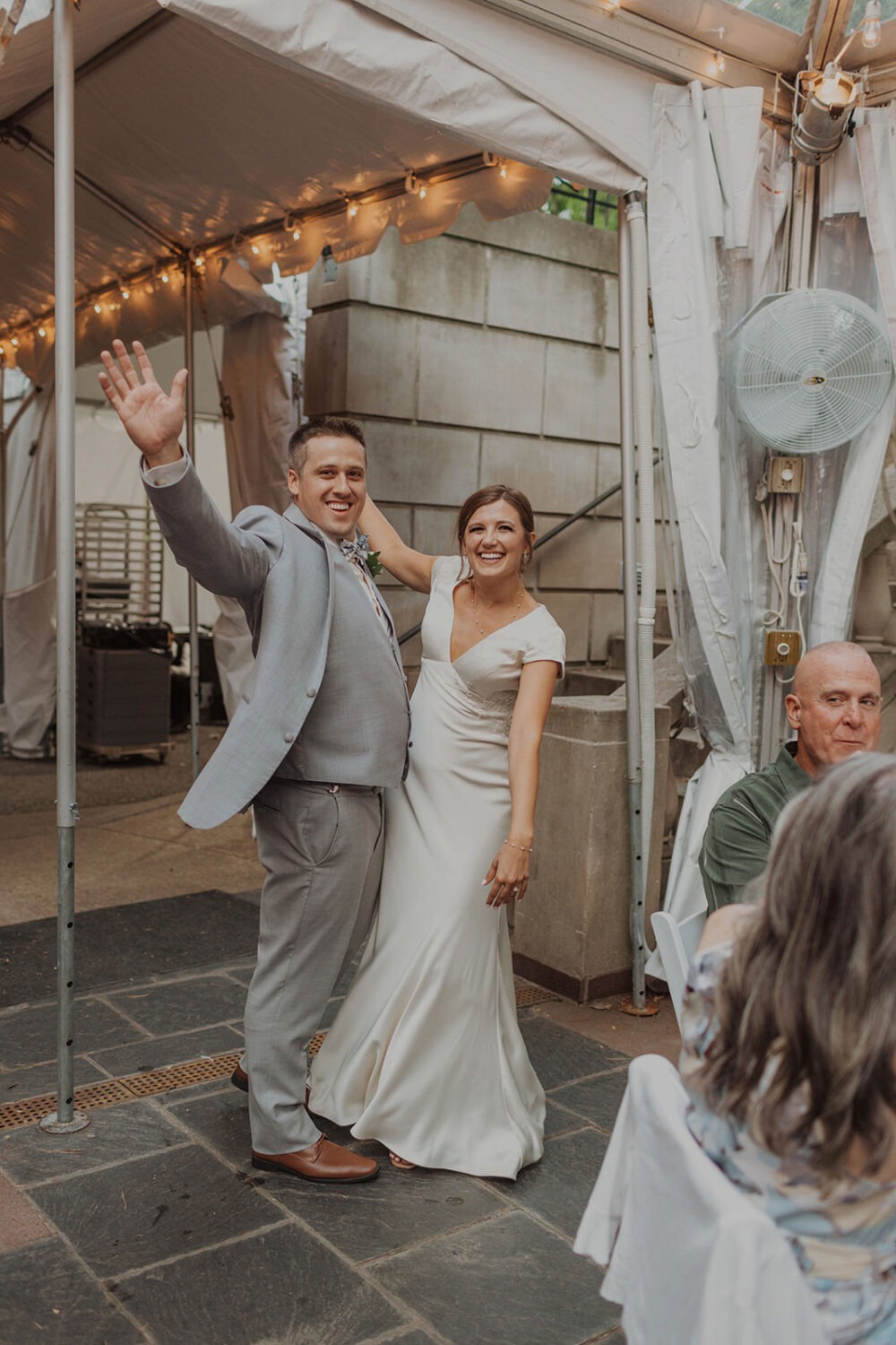 couple enters tent wedding reception