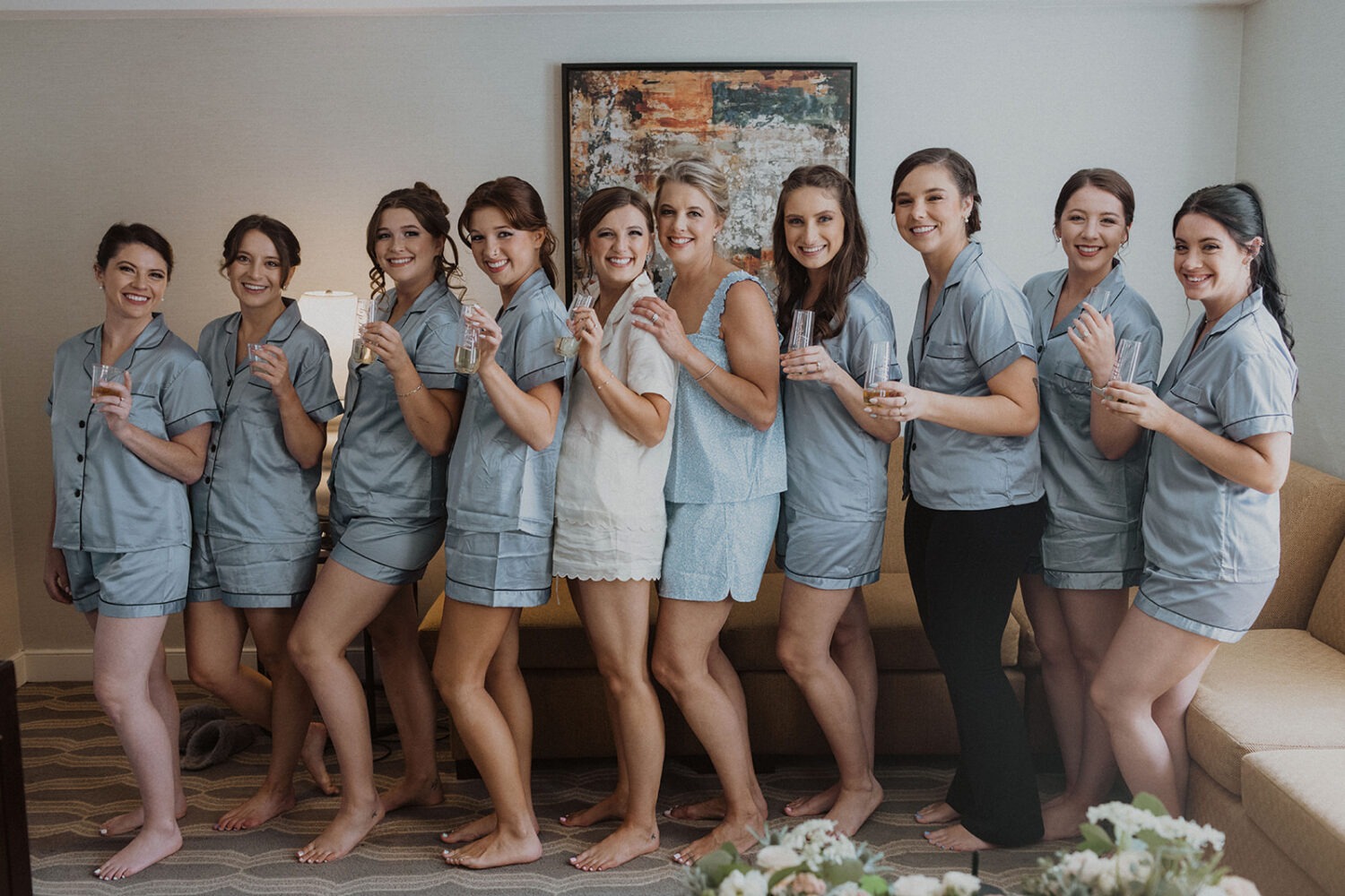 bride poses with bridesmaids in matching PJ's