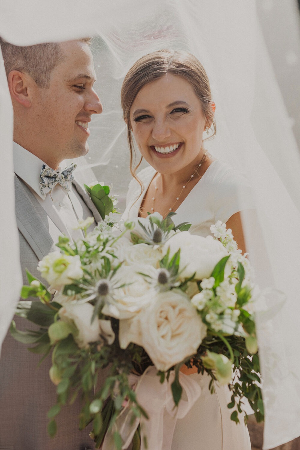 couple embraces under wedding veil at Dumbarton House wedding