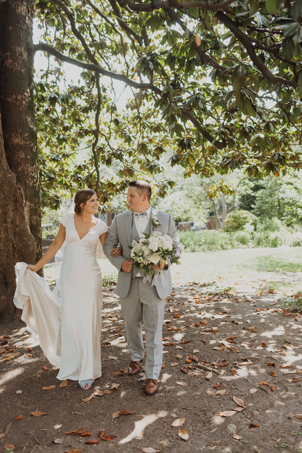 couple walks in garden at Dumbarton House wedding