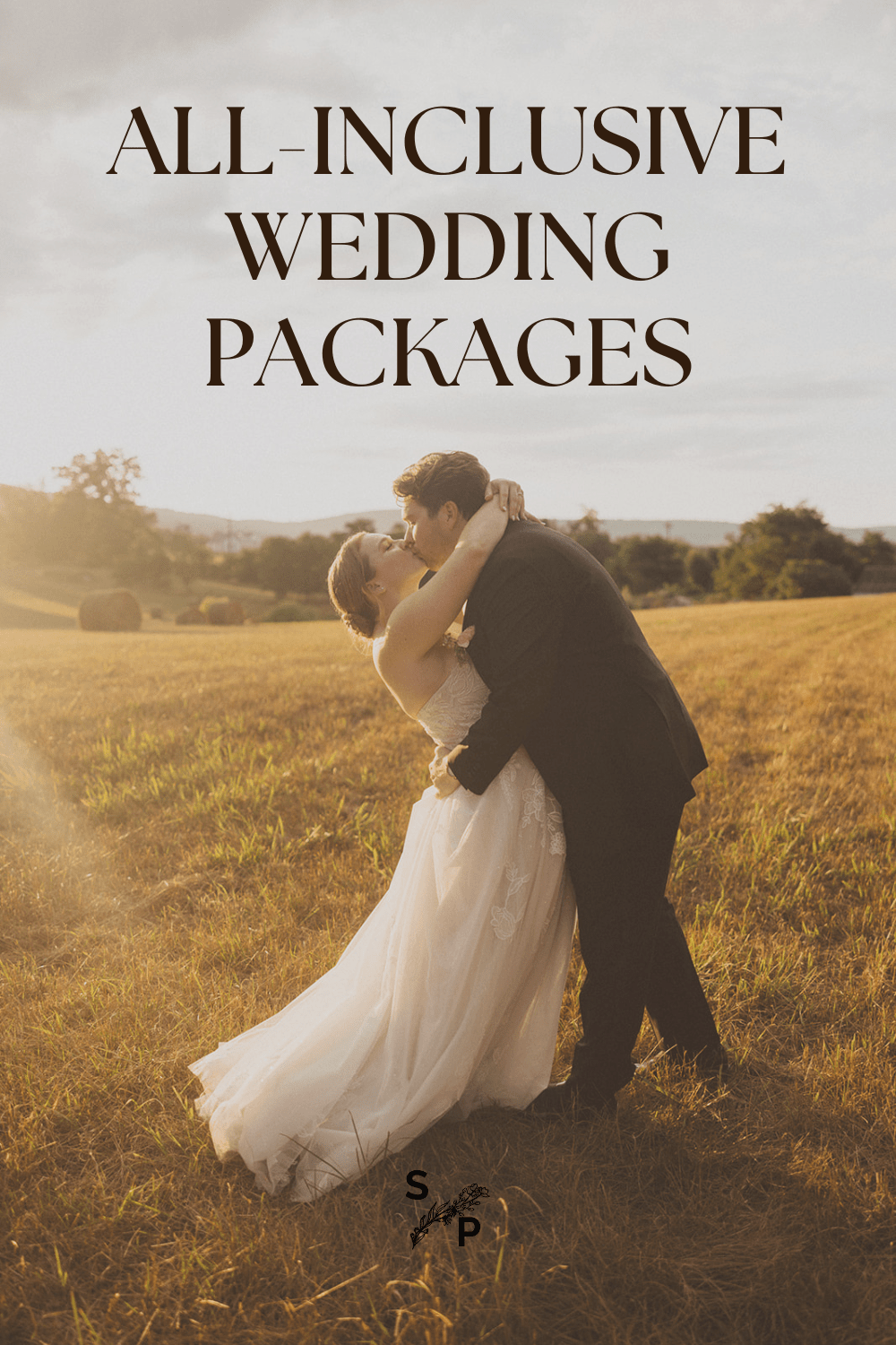 couple kisses in sunset field at outdoor wedding