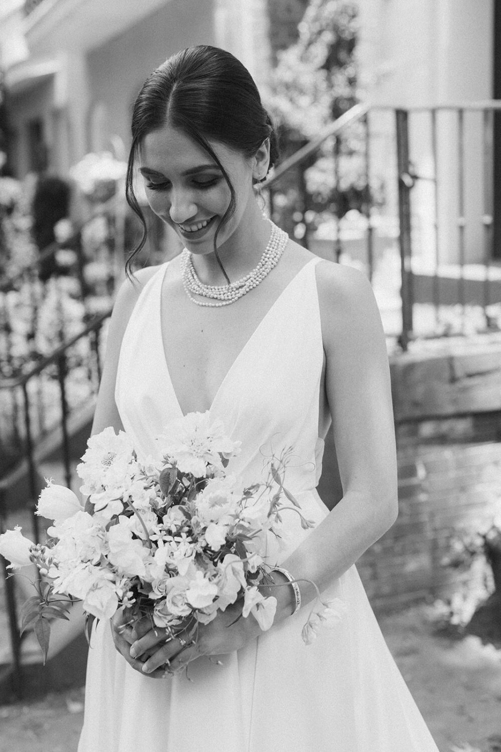 bride holds white wedding bouquet during wedding bridals