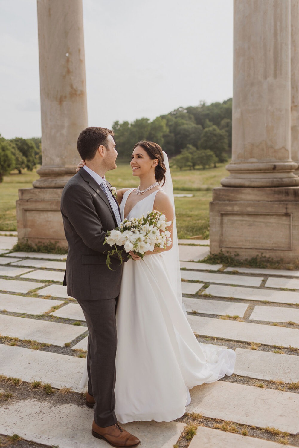 couple kisses under Capitol Columns at National Arboretum DC wedding