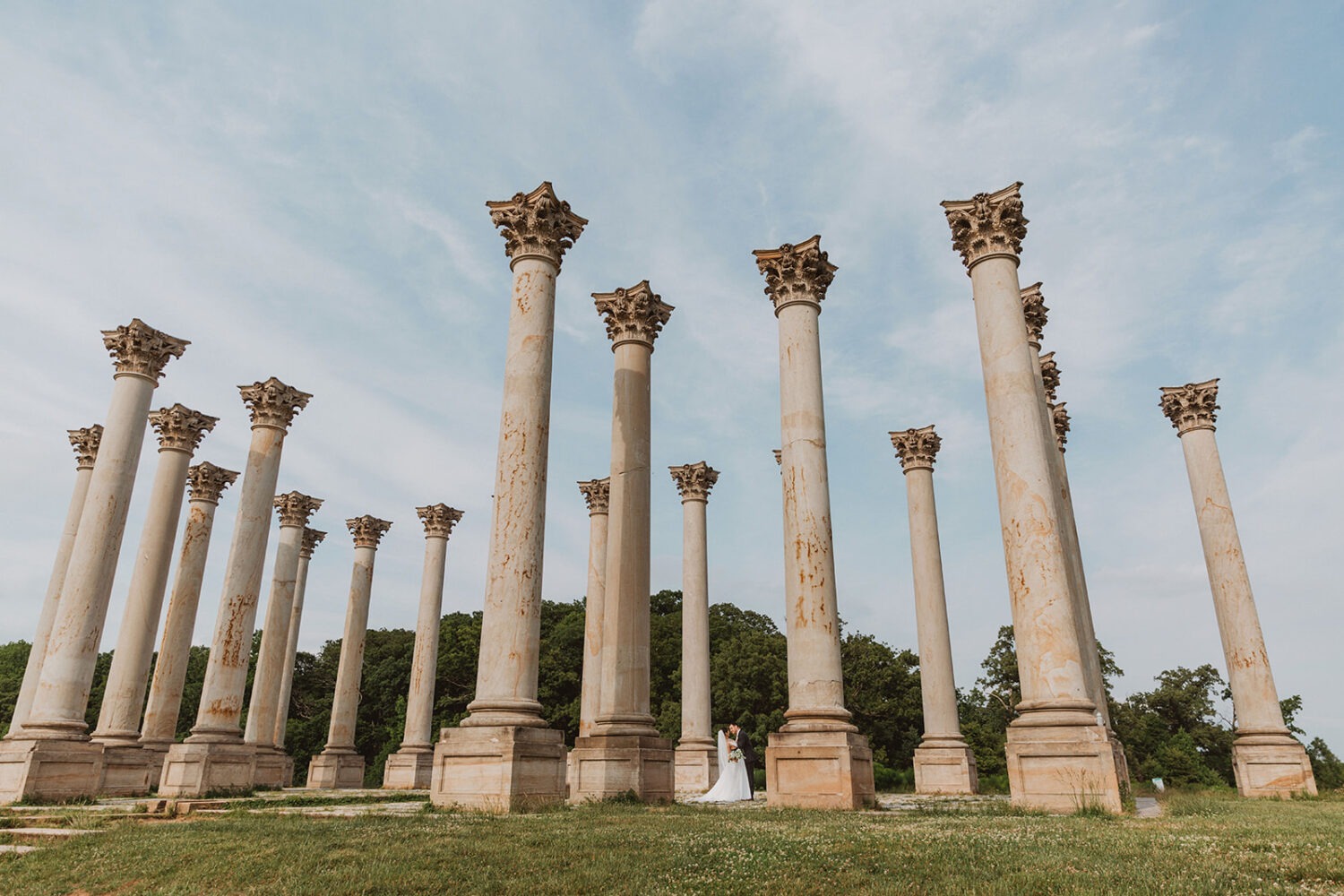 couple kisses under Capitol Columns at National Arboretum DC wedding