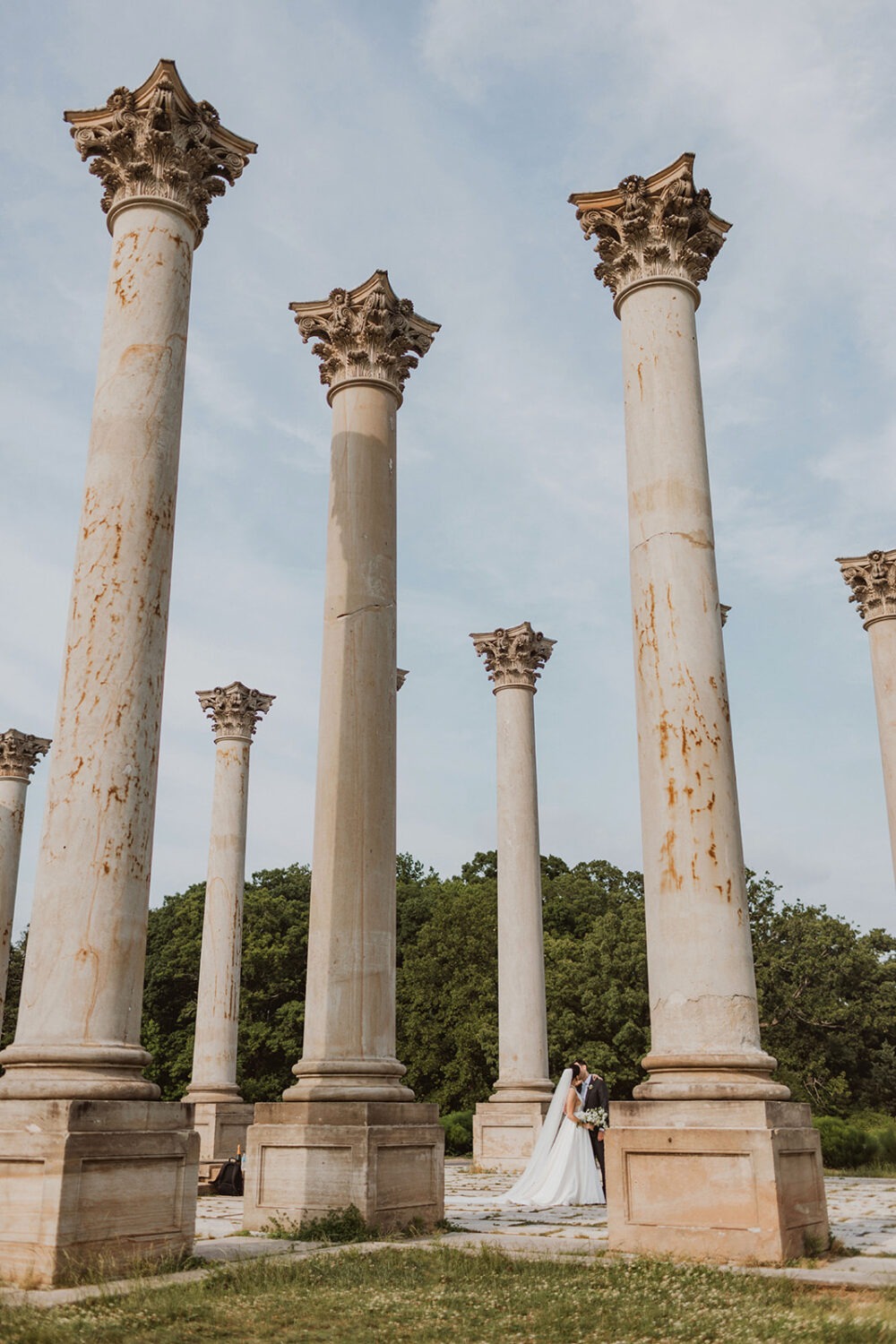 couple kisses under Capitol Columns at National Arboretum DC wedding