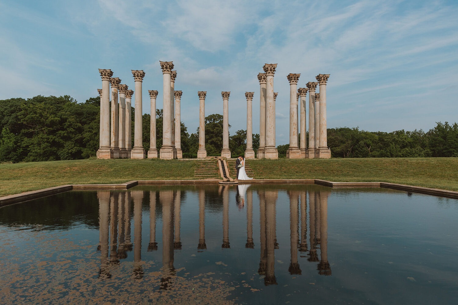 couple kisses under Capitol Columns at National Arboretum DC wedding