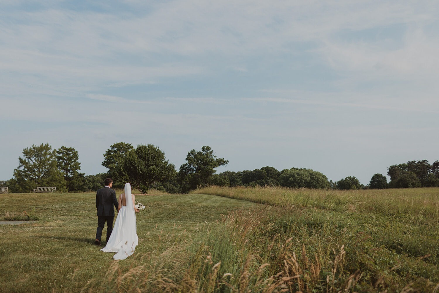 couple walks holding hands at National Arboretum DC wedding