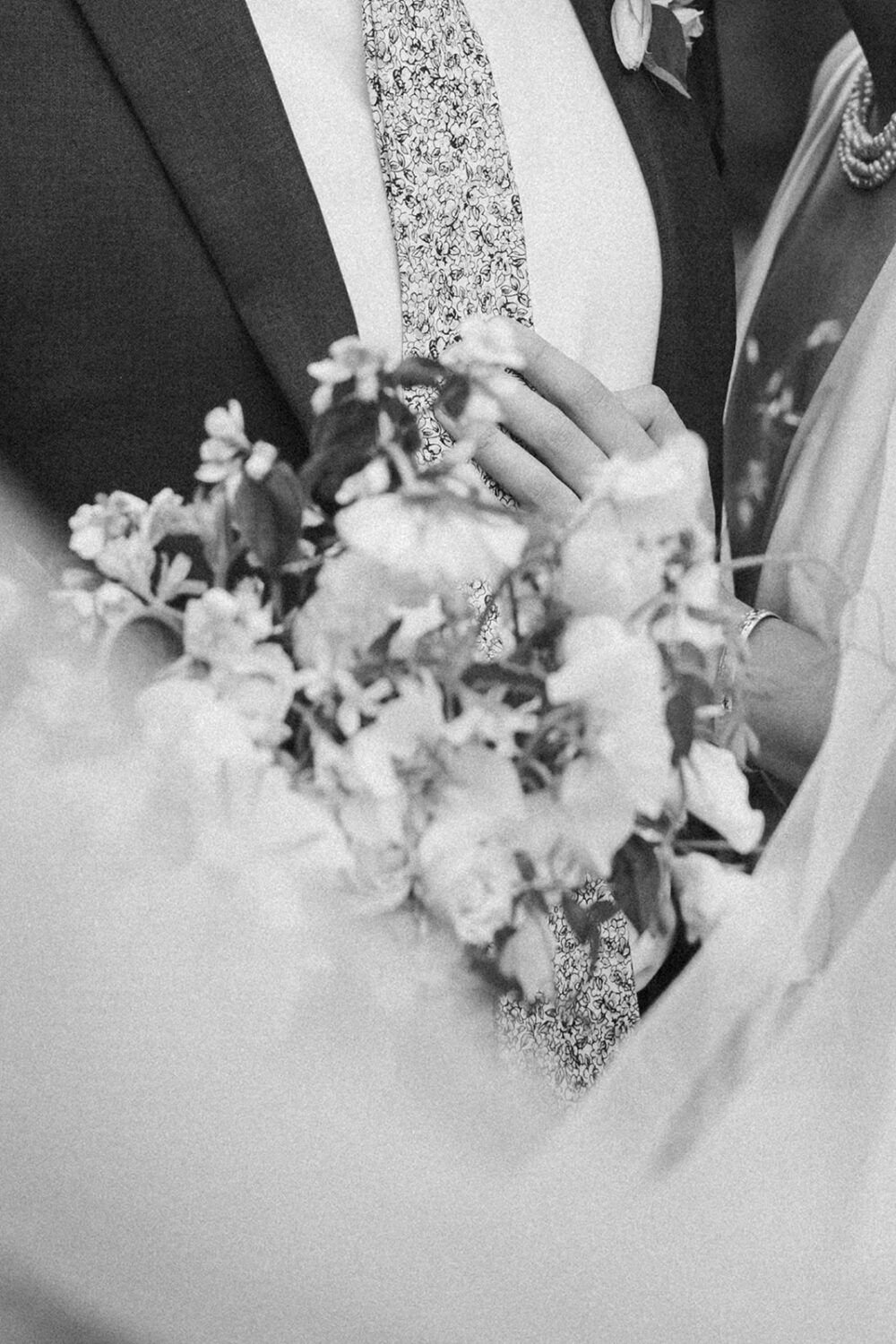 white wedding bouquet wrapped in veil