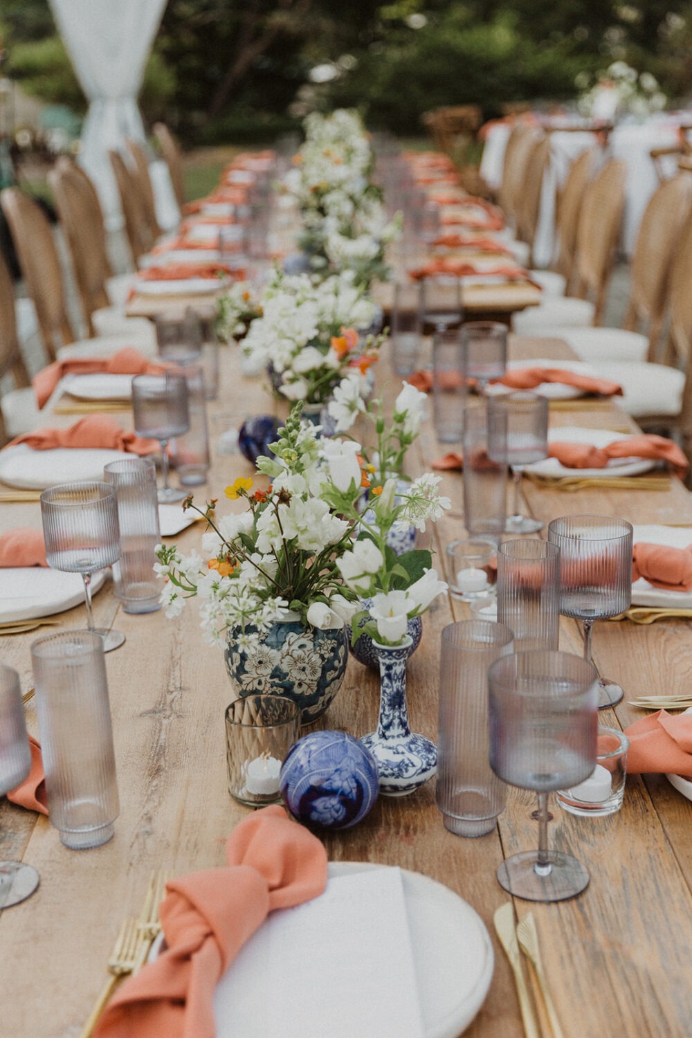 white and blue porcelain wedding decor at outdoor wedding with tent