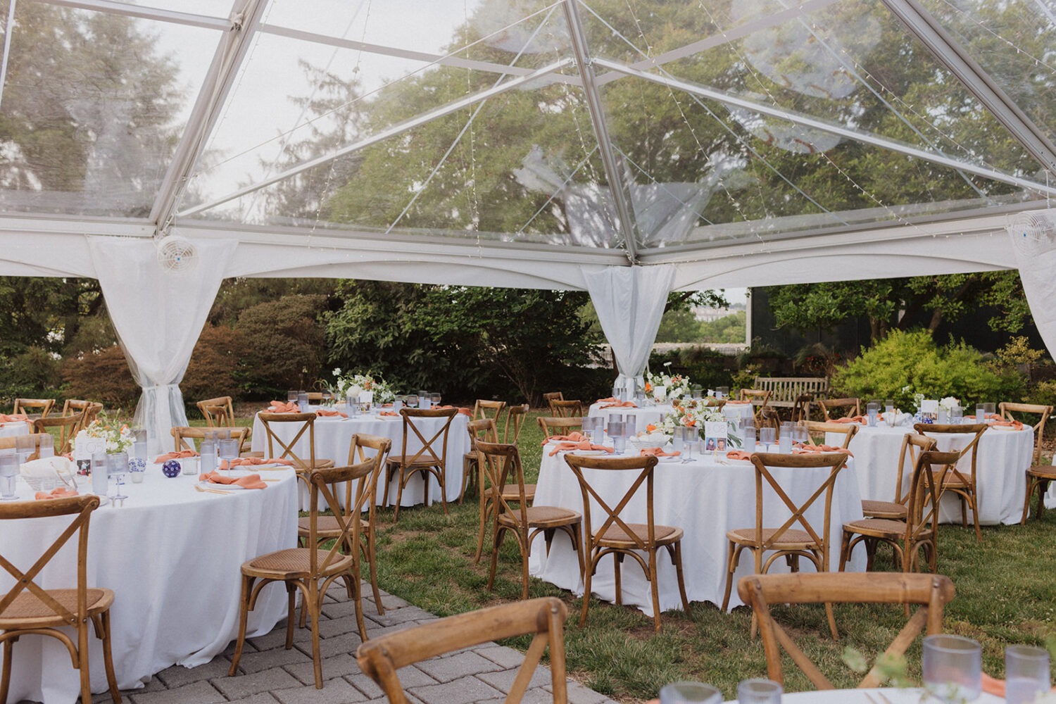 table settings at outdoor wedding with tent 