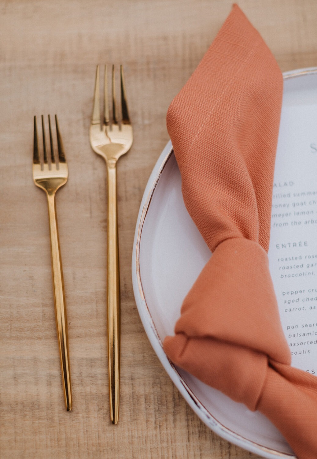 gold and coral wedding table setting at outdoor wedding with tent