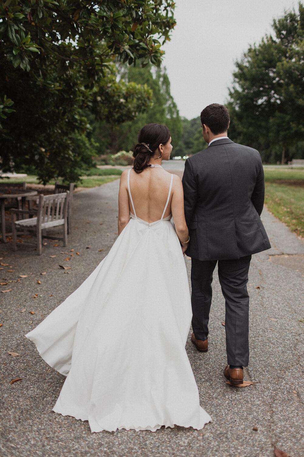 couple walks holding hands at National Arboretum DC wedding
