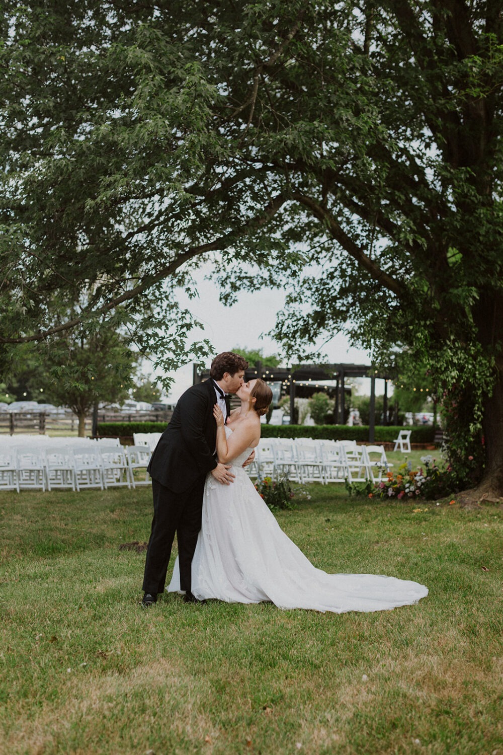 couple kisses at backyard wedding