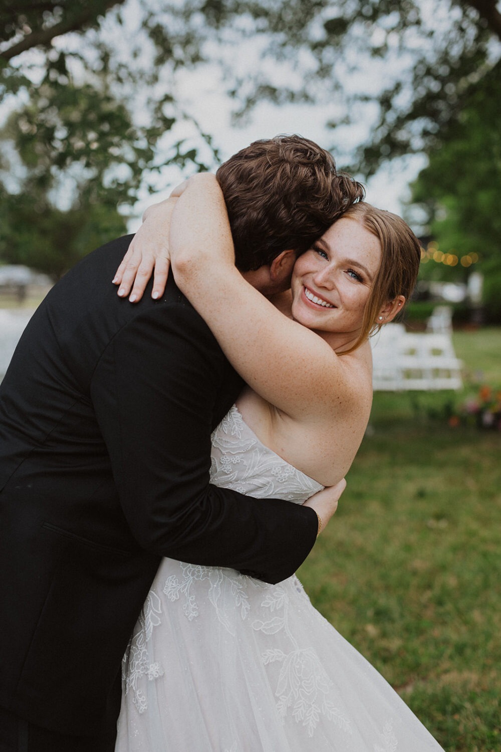 couple embraces at outdoor wedding