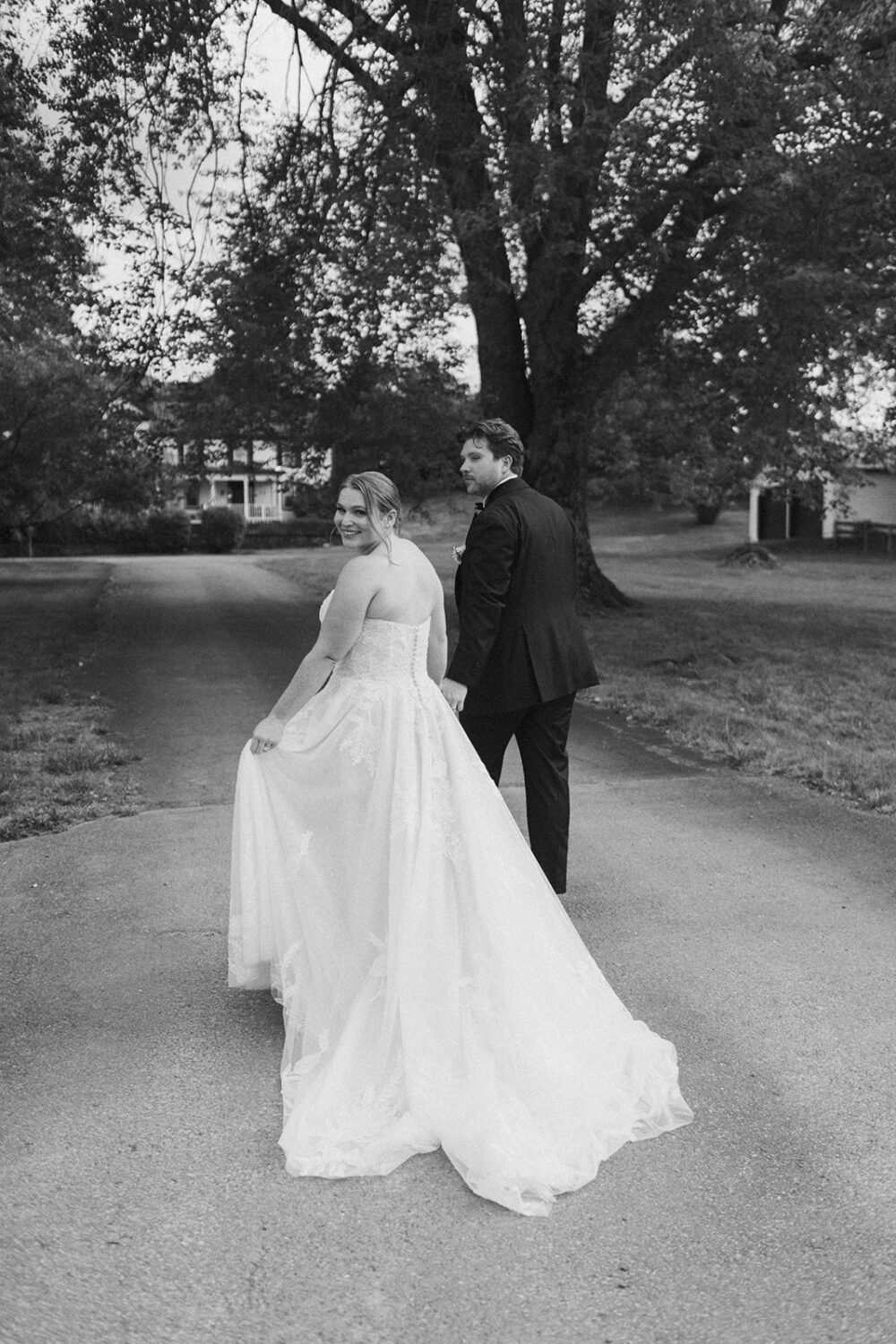 couple walks holding hands at The Manor at Airmont wedding