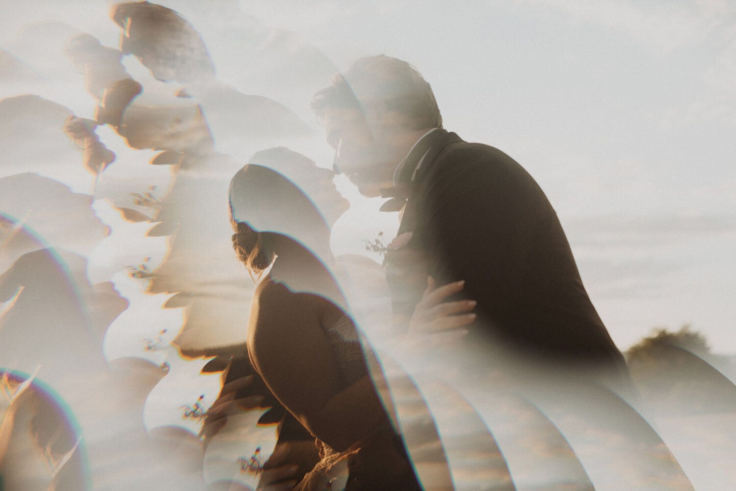 couple embraces at outdoor wedding 