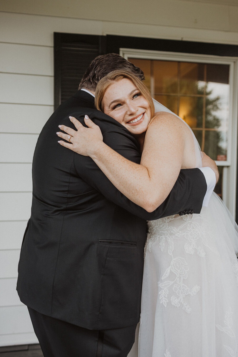 bride hugs dad during wedding first look 