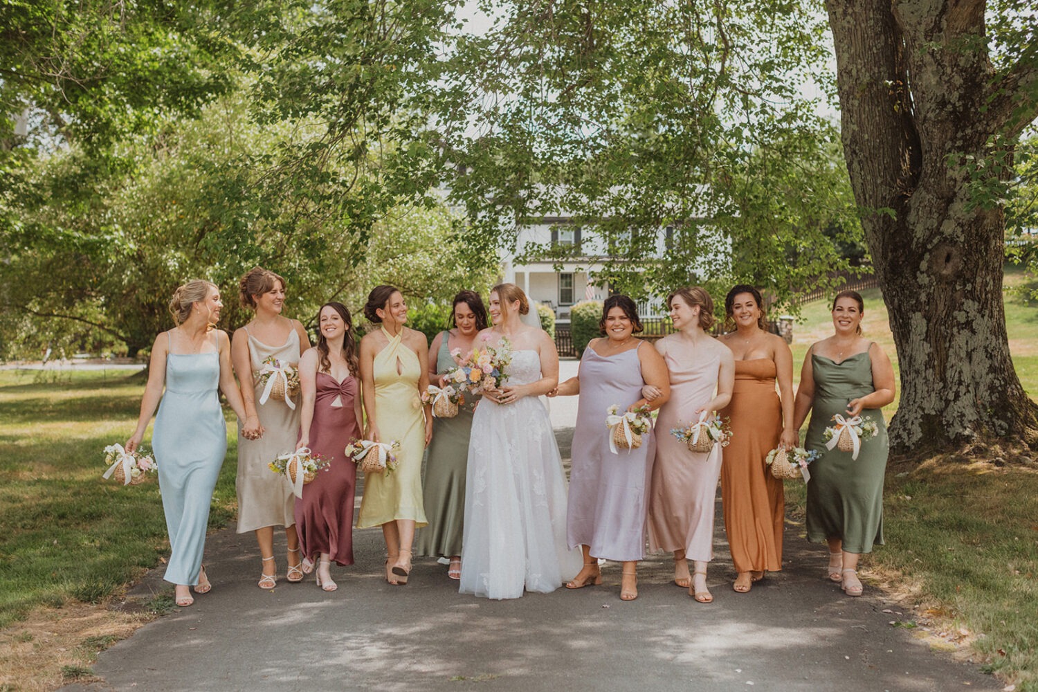 bride walks with bridesmaids at The Manor at Airmont wedding