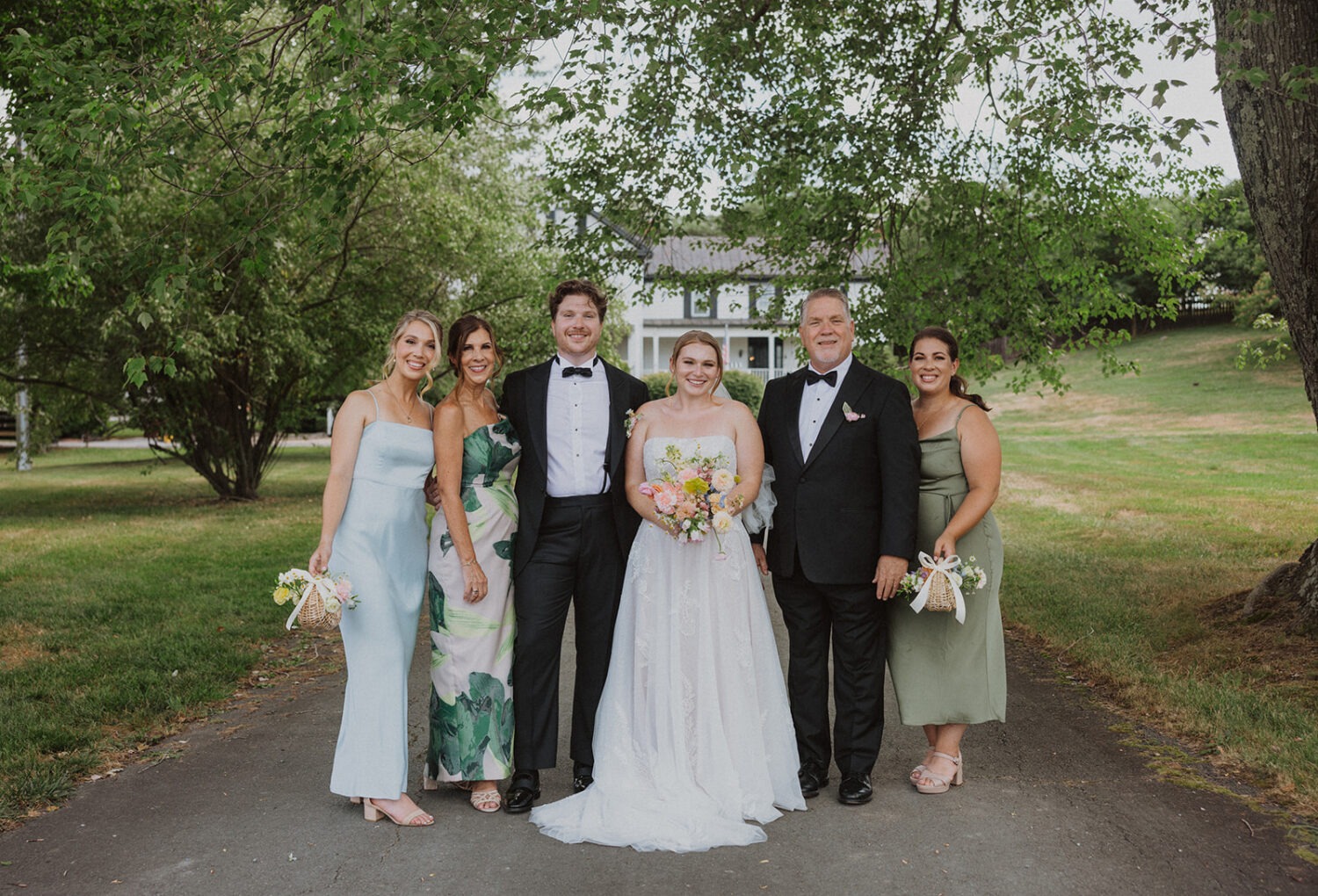 couple poses with family at historic estate wedding