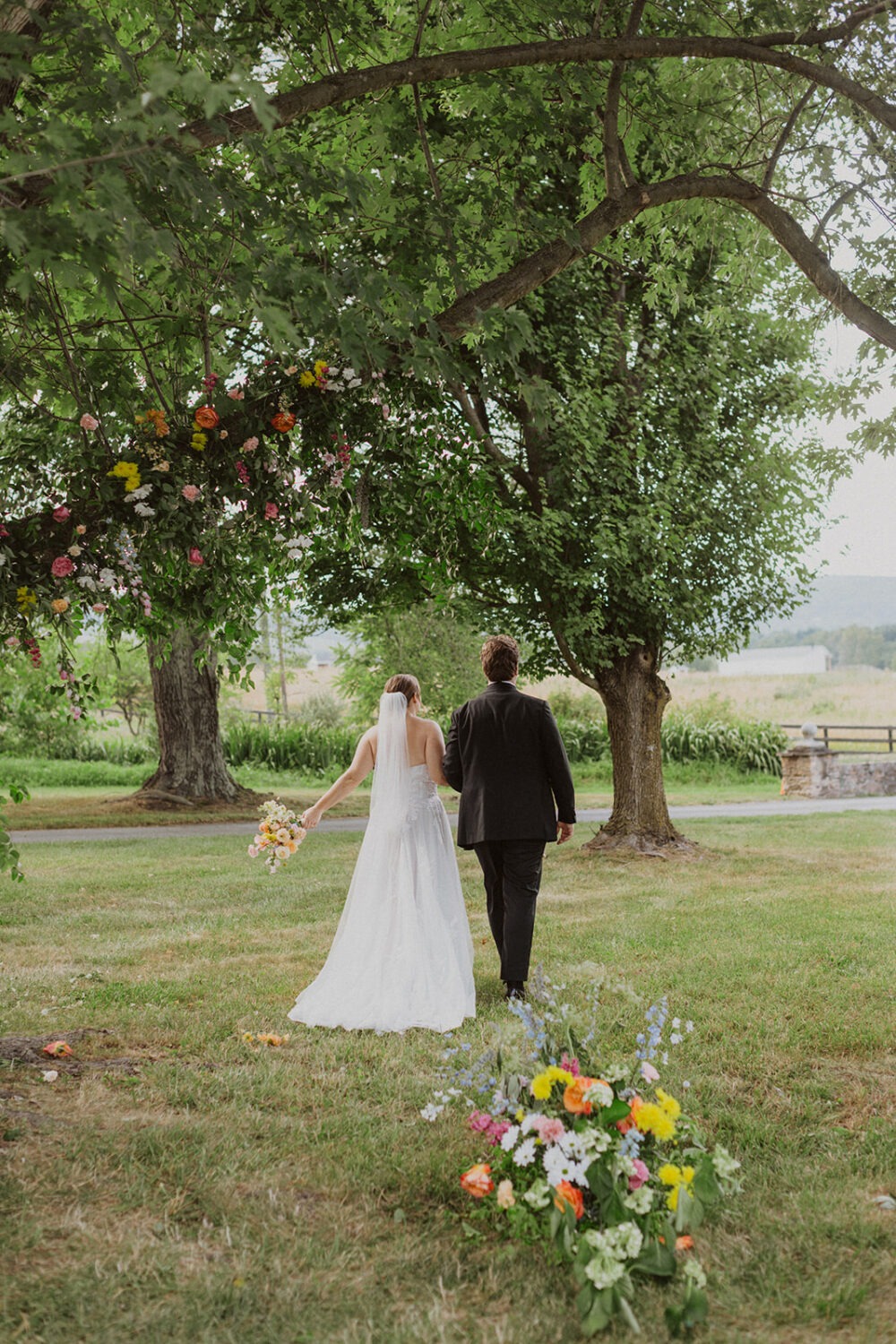 couple walks together at outdoor wedding venue