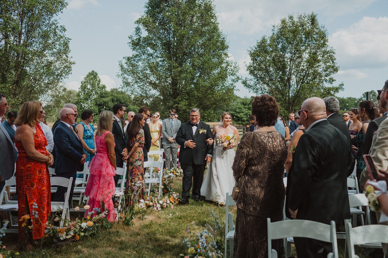 bride walks down aisle during wedding ceremony