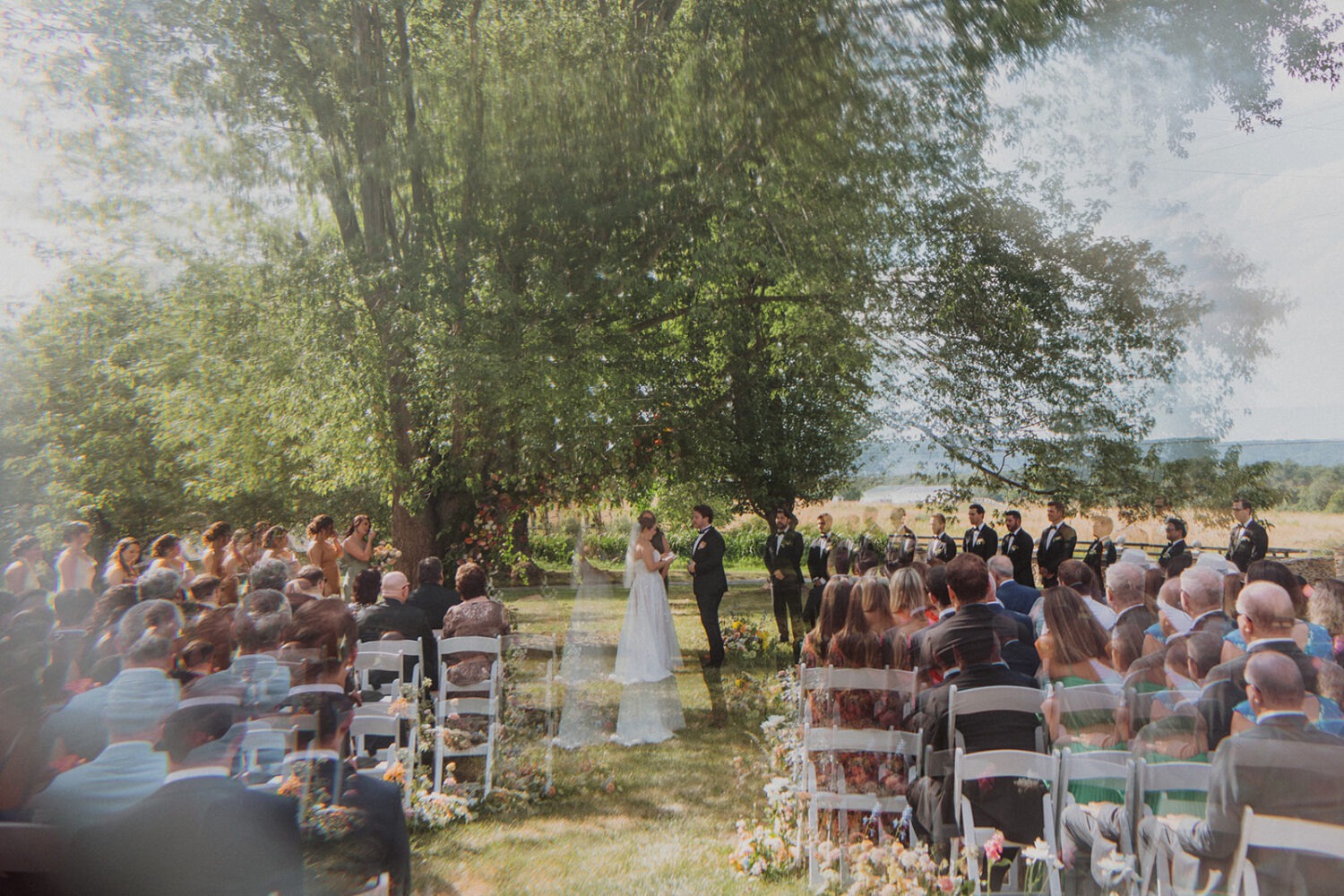 couple exchanges vows at outdoor wedding ceremony