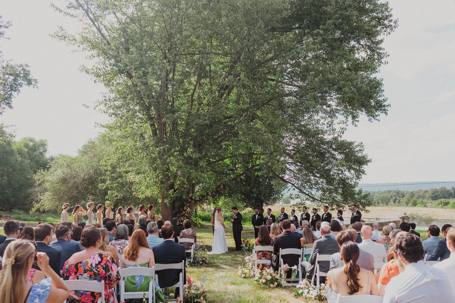 couple exchanges vows at outdoor wedding ceremony