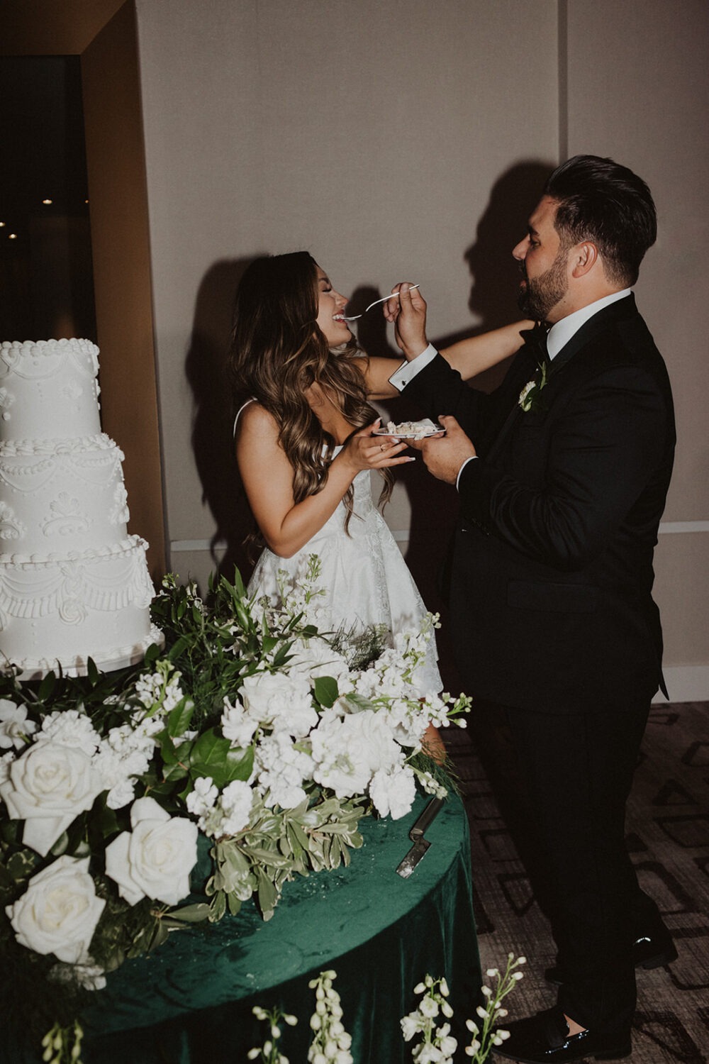 couple eats cake during wedding reception