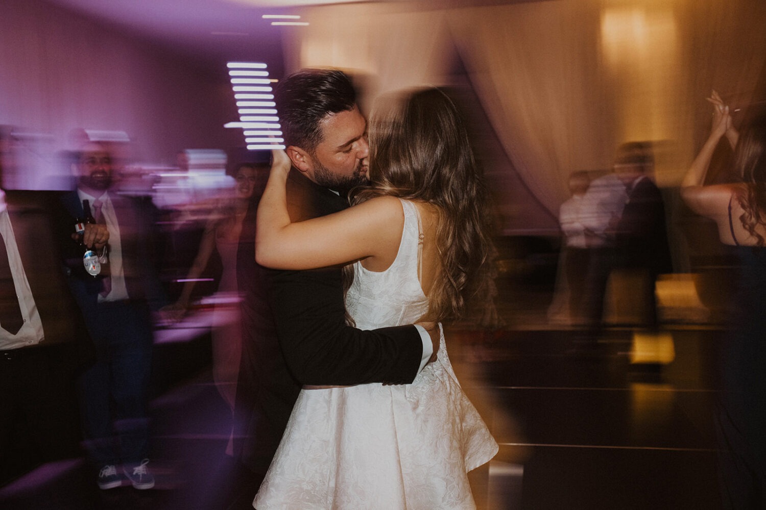 couple kisses during wedding reception