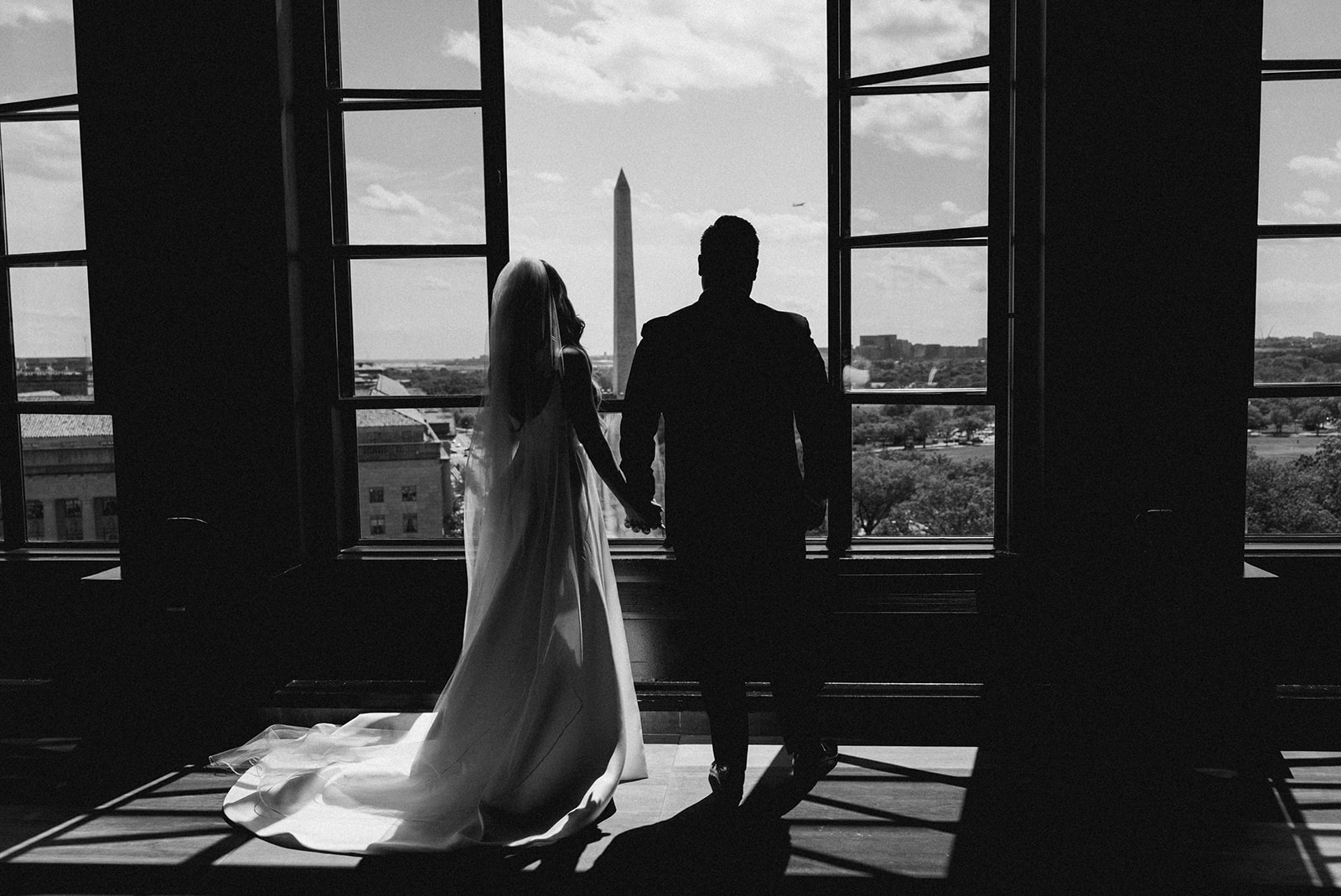 couple holds hands at DC rooftop wedding