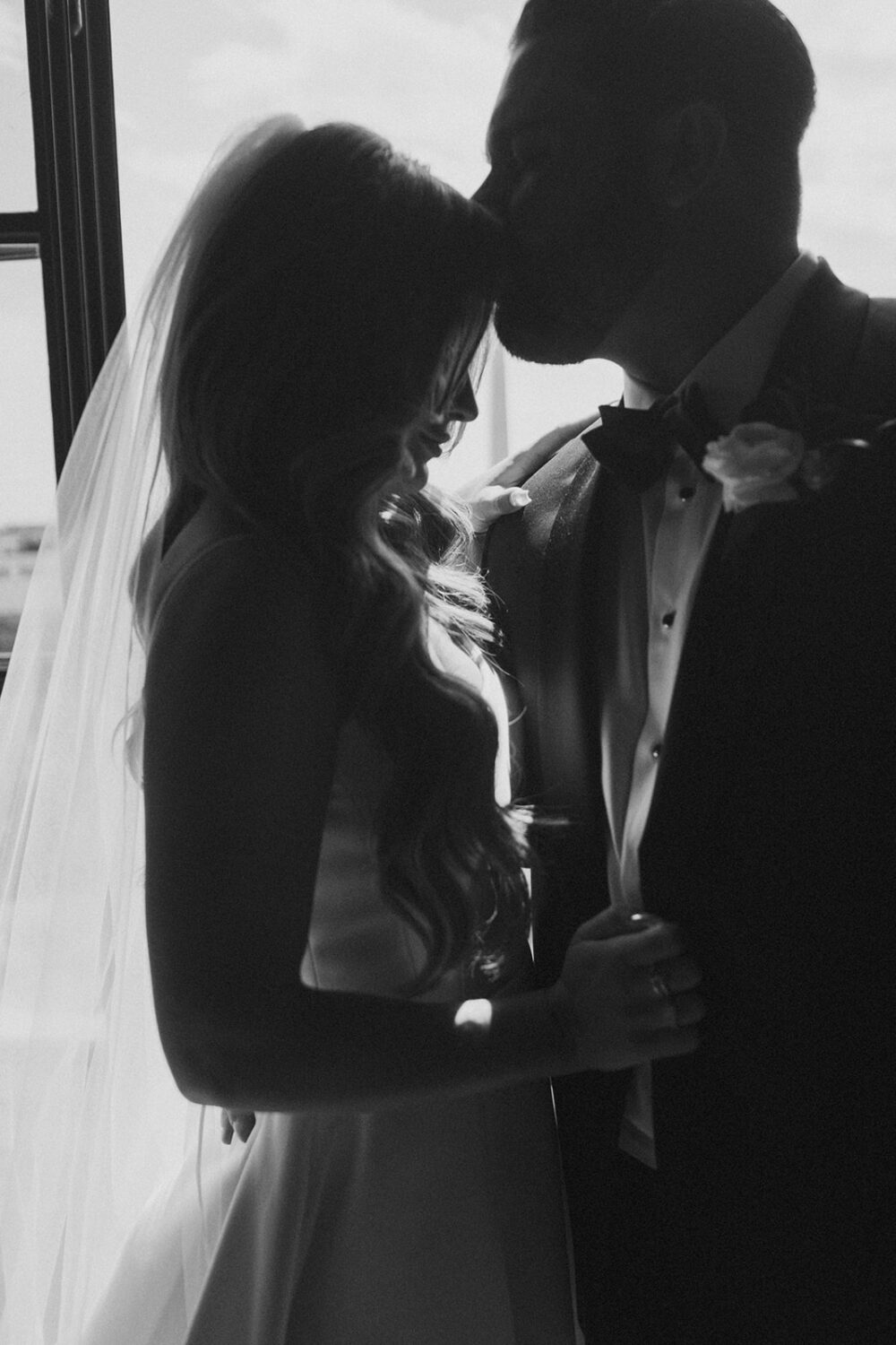 groom kisses bride's forehead for wedding photo shoot ideas