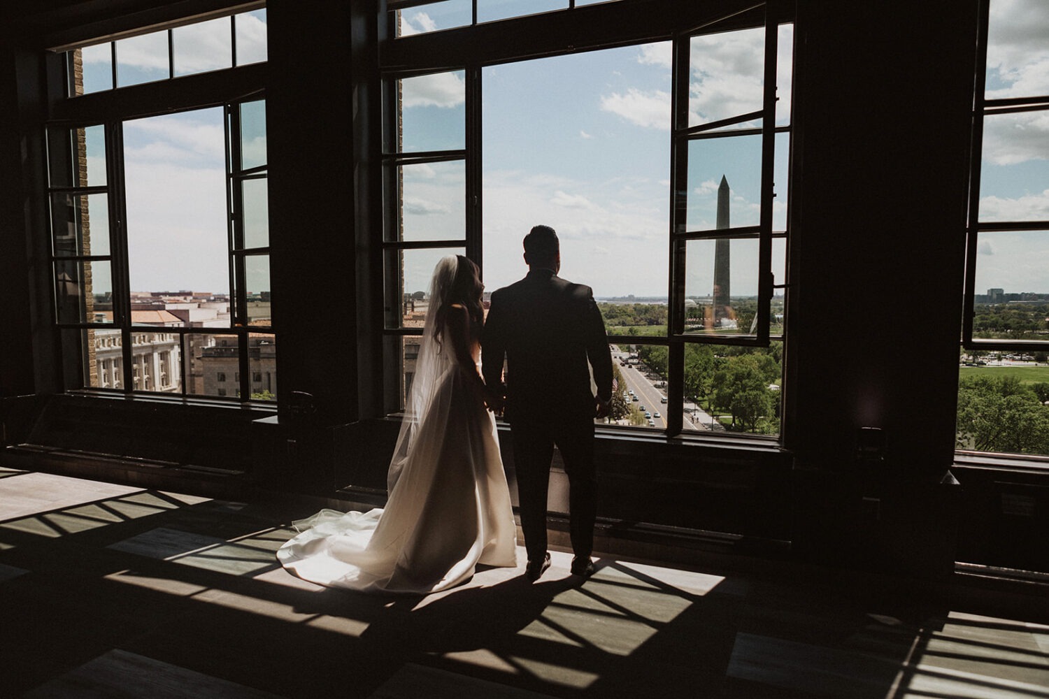 couple looks out Hotel Washington for wedding photo shoot ideas