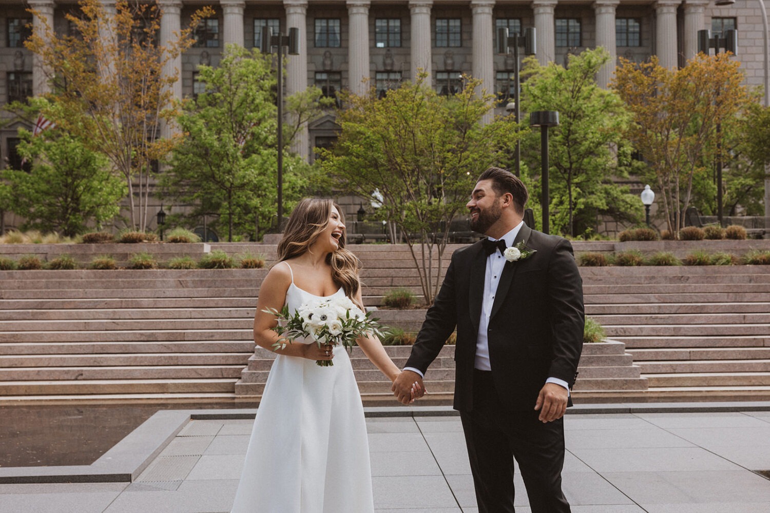 couple holds hands at outdoor Washington DC wedding