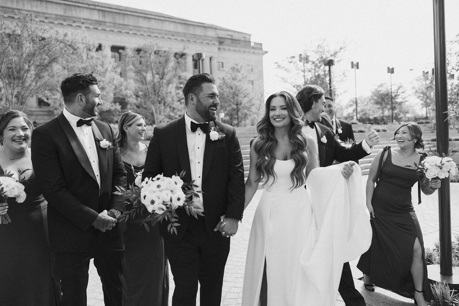 couple walks with wedding party at outdoor DC wedding 