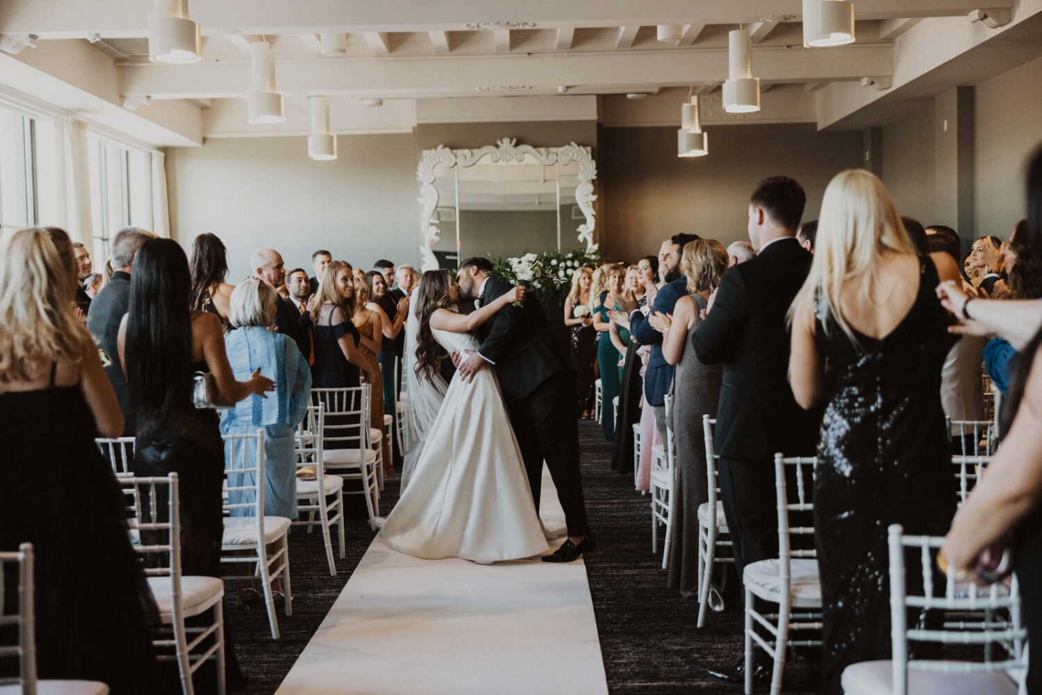 couple kisses in aisle at Hotel Washington wedding 