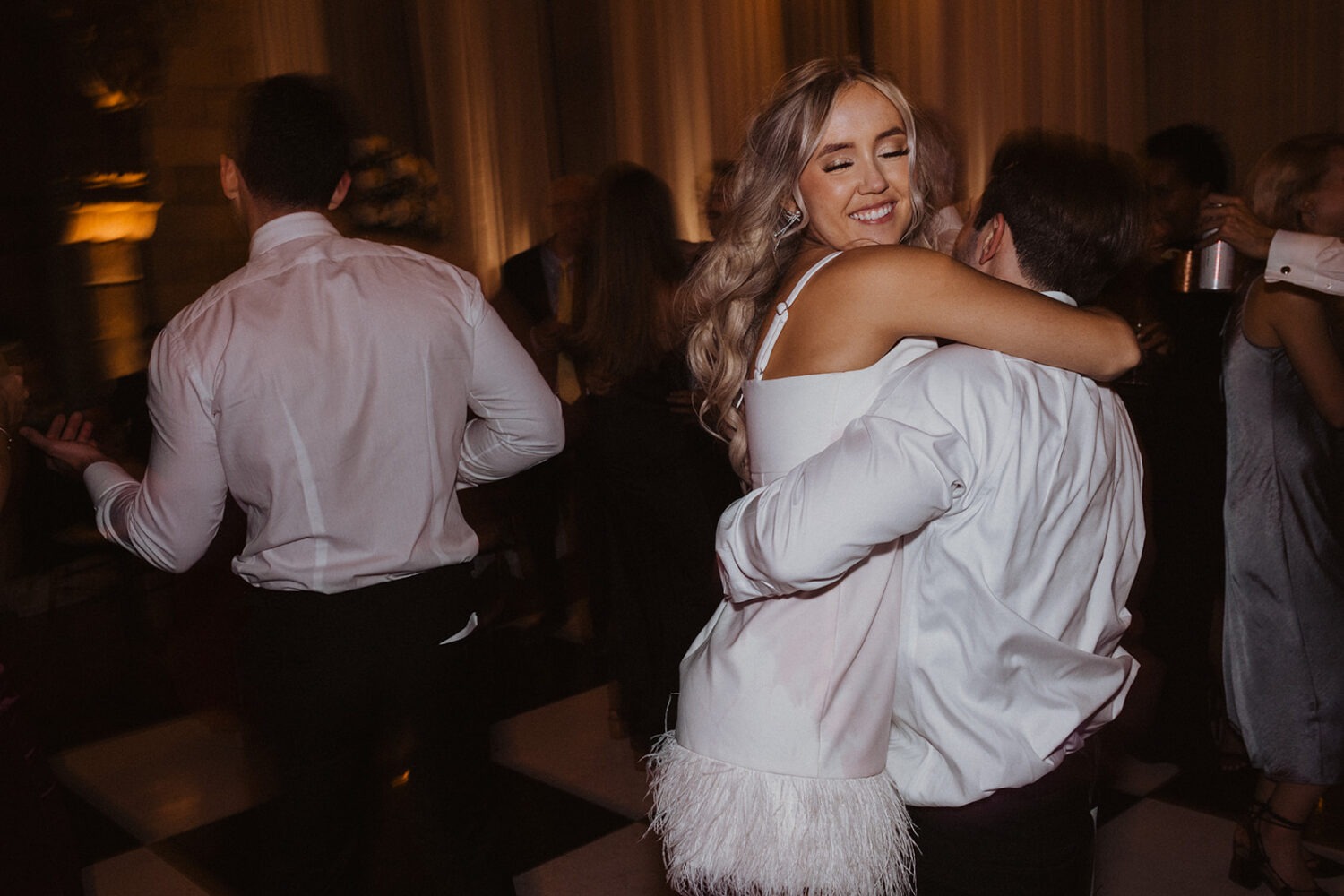 couple embraces on dance floor during wedding reception 