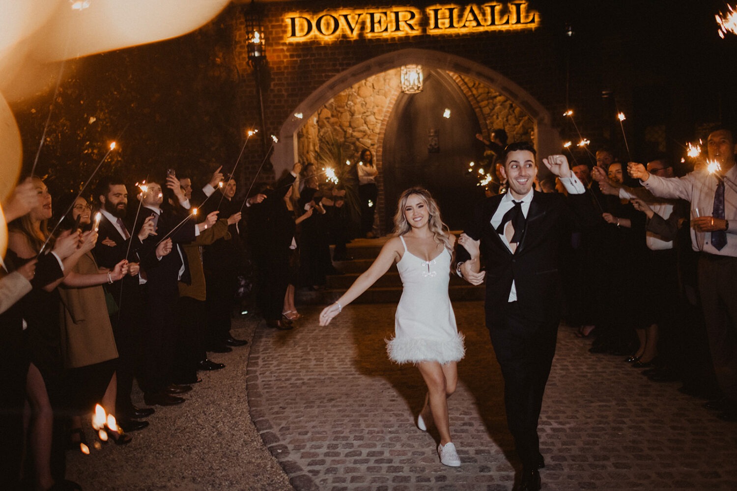 couple exits under sparklers at Dover Hall Virginia wedding venue