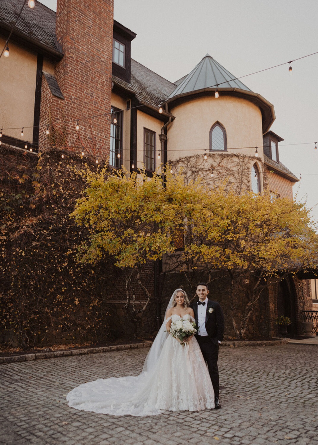 couple stands under Dover Hall Virginia wedding venue