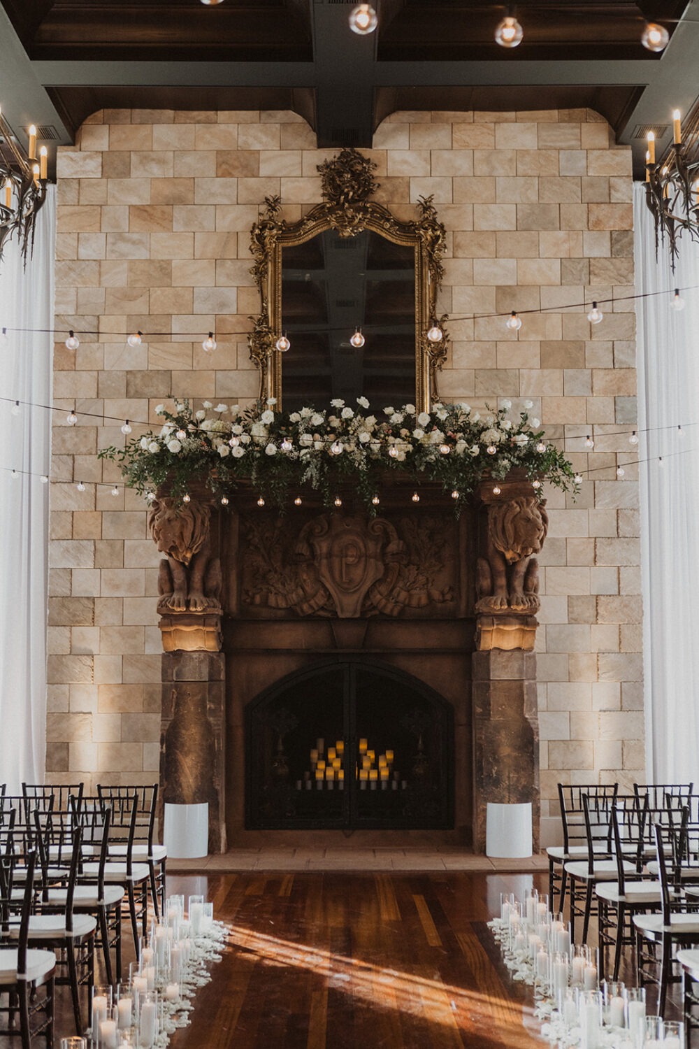 white and black wedding ceremony decor and florals on fireplace