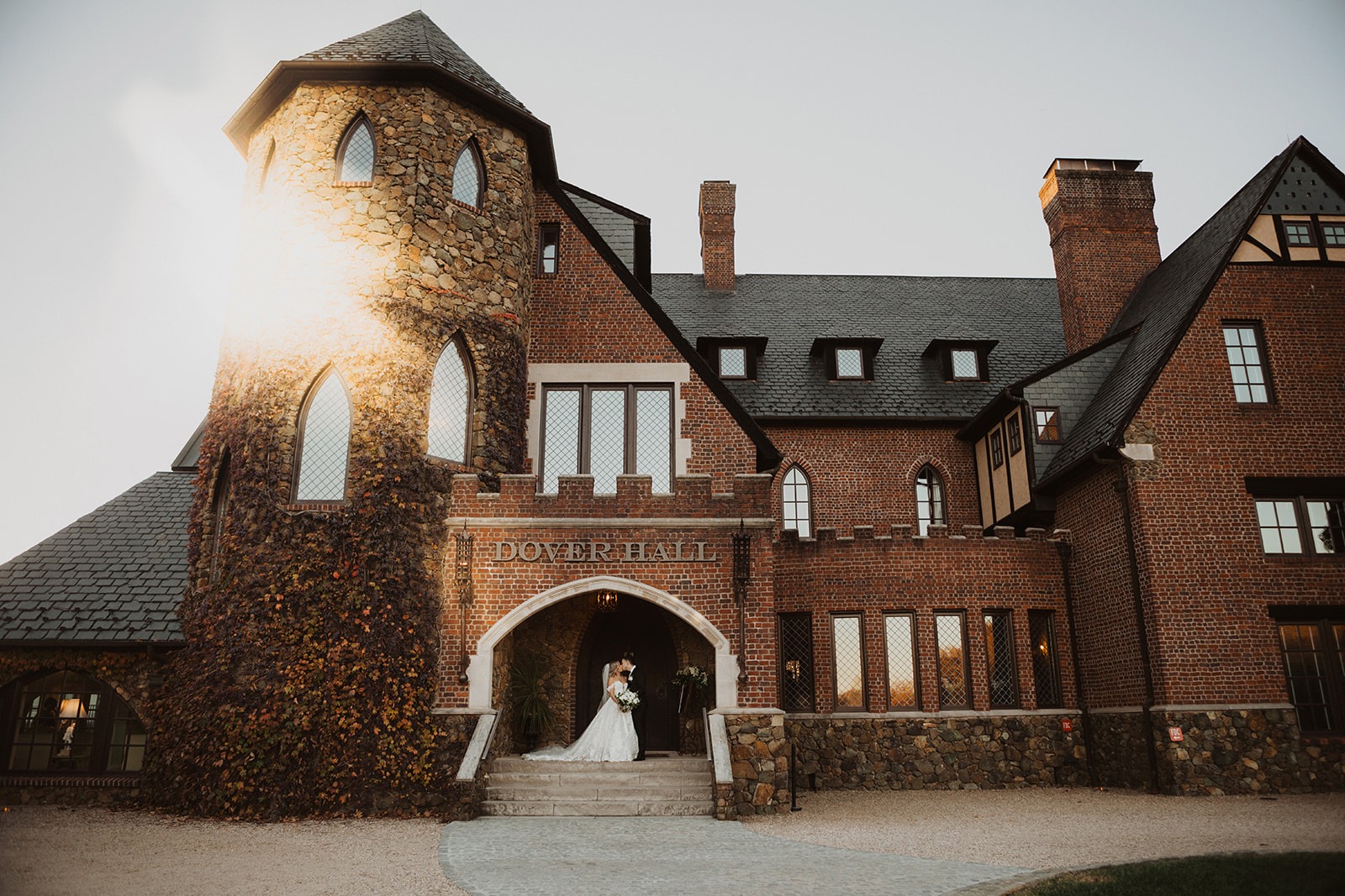 couple kisses on front steps of Dover Hall Virginia wedding venue