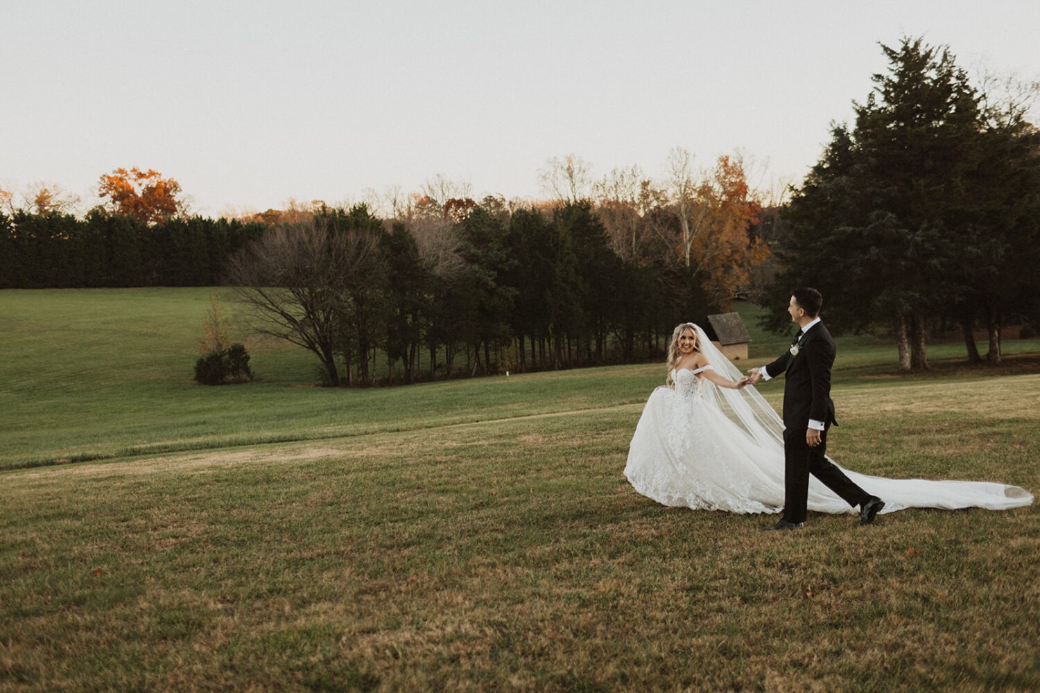 couple walks holding hands at historic Virginia wedding estate