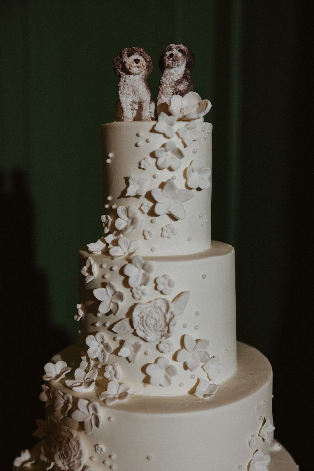 white wedding cake with dog cake toppers