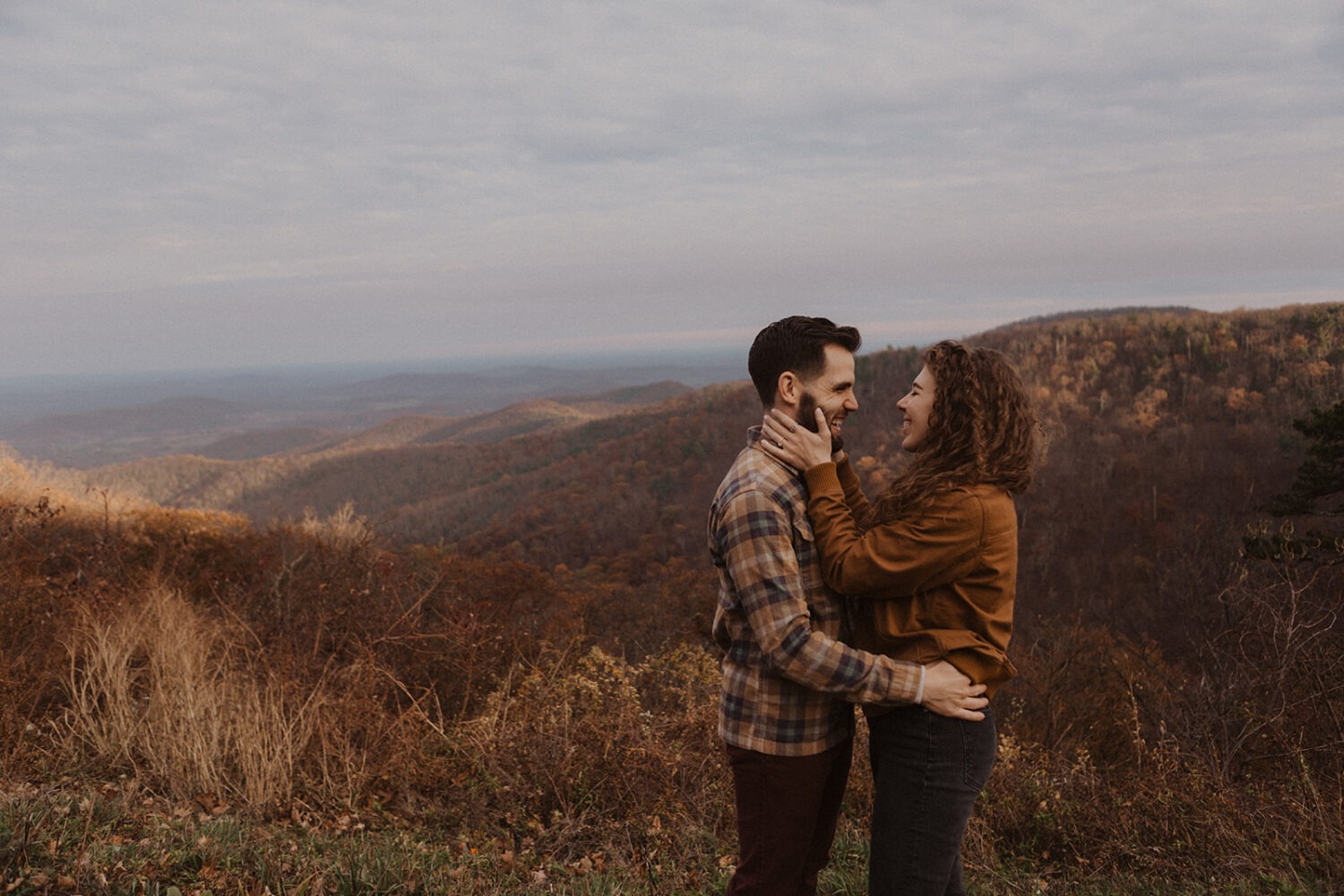 couple embraces during Shenandoah sunset engagement session