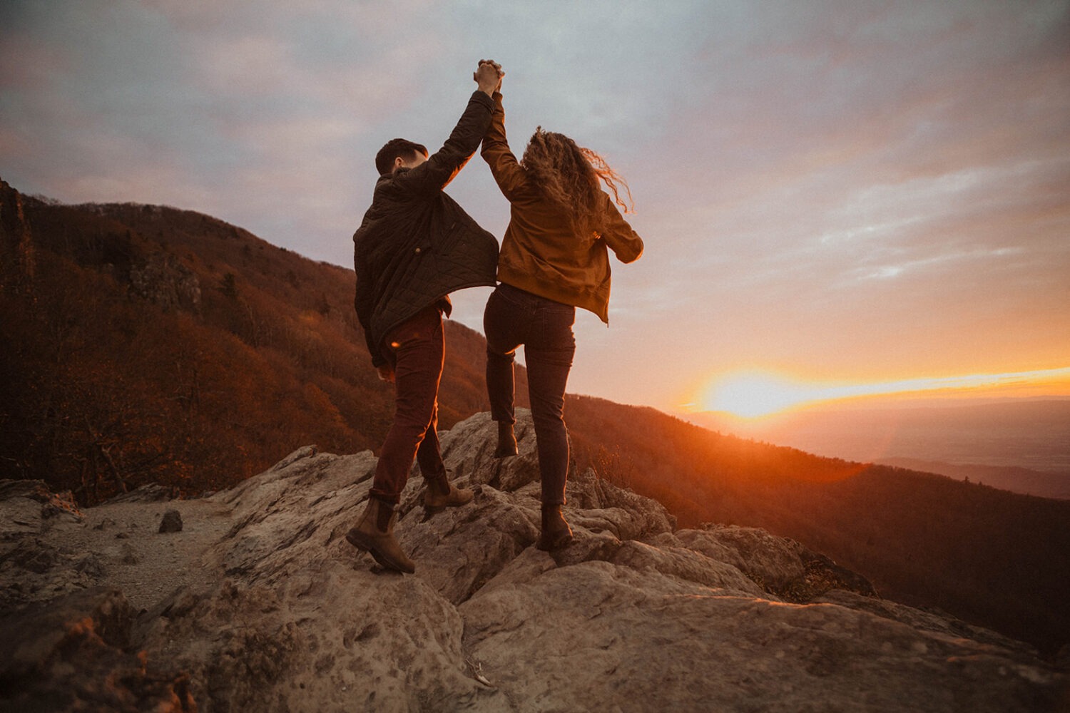 couple stands on overlook for Shenandoah fall engagement photos